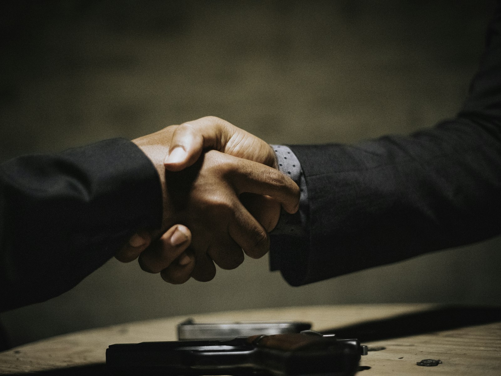 A contract being signed across a table.