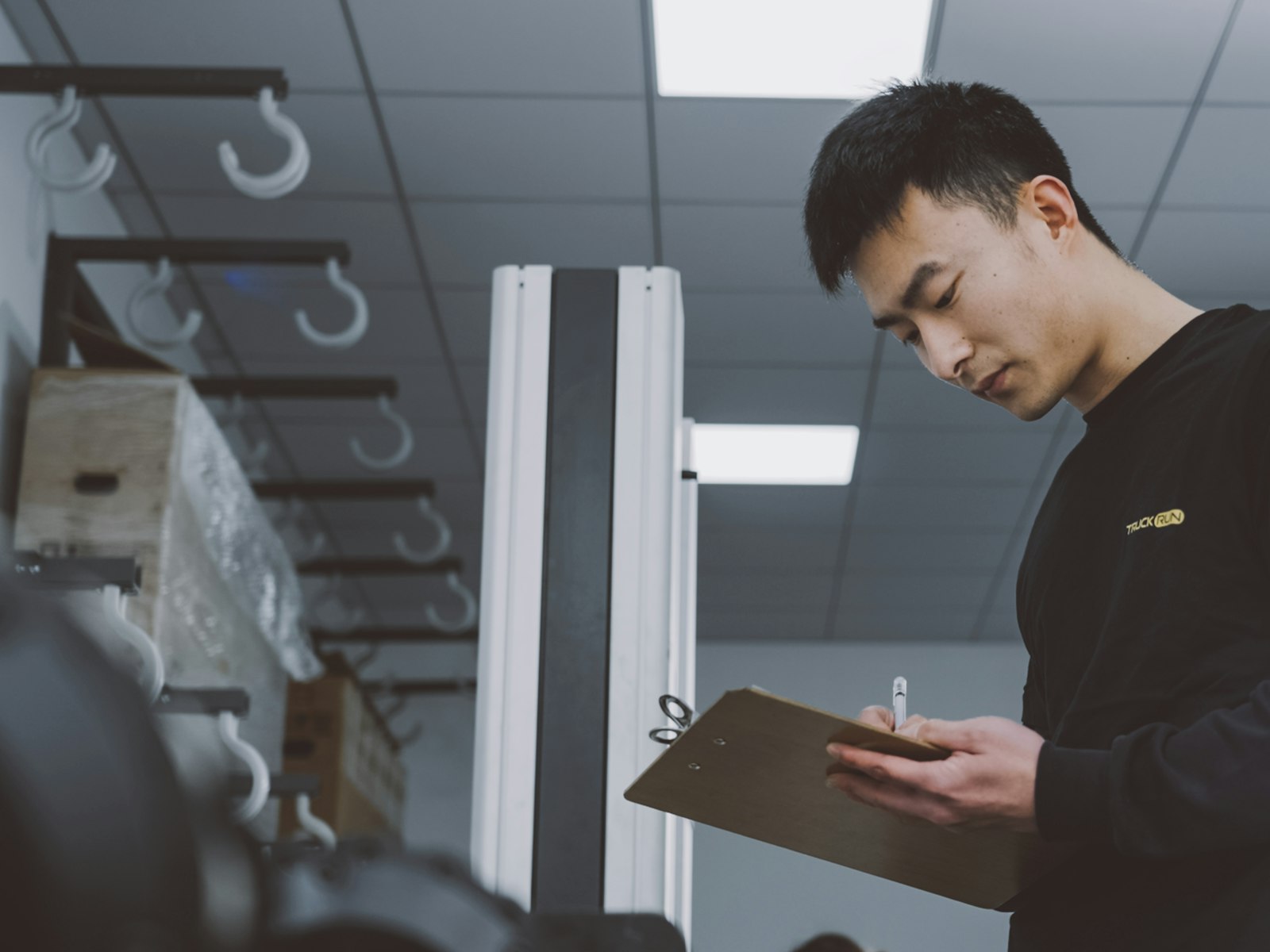 An inspector checking goods against a specification.